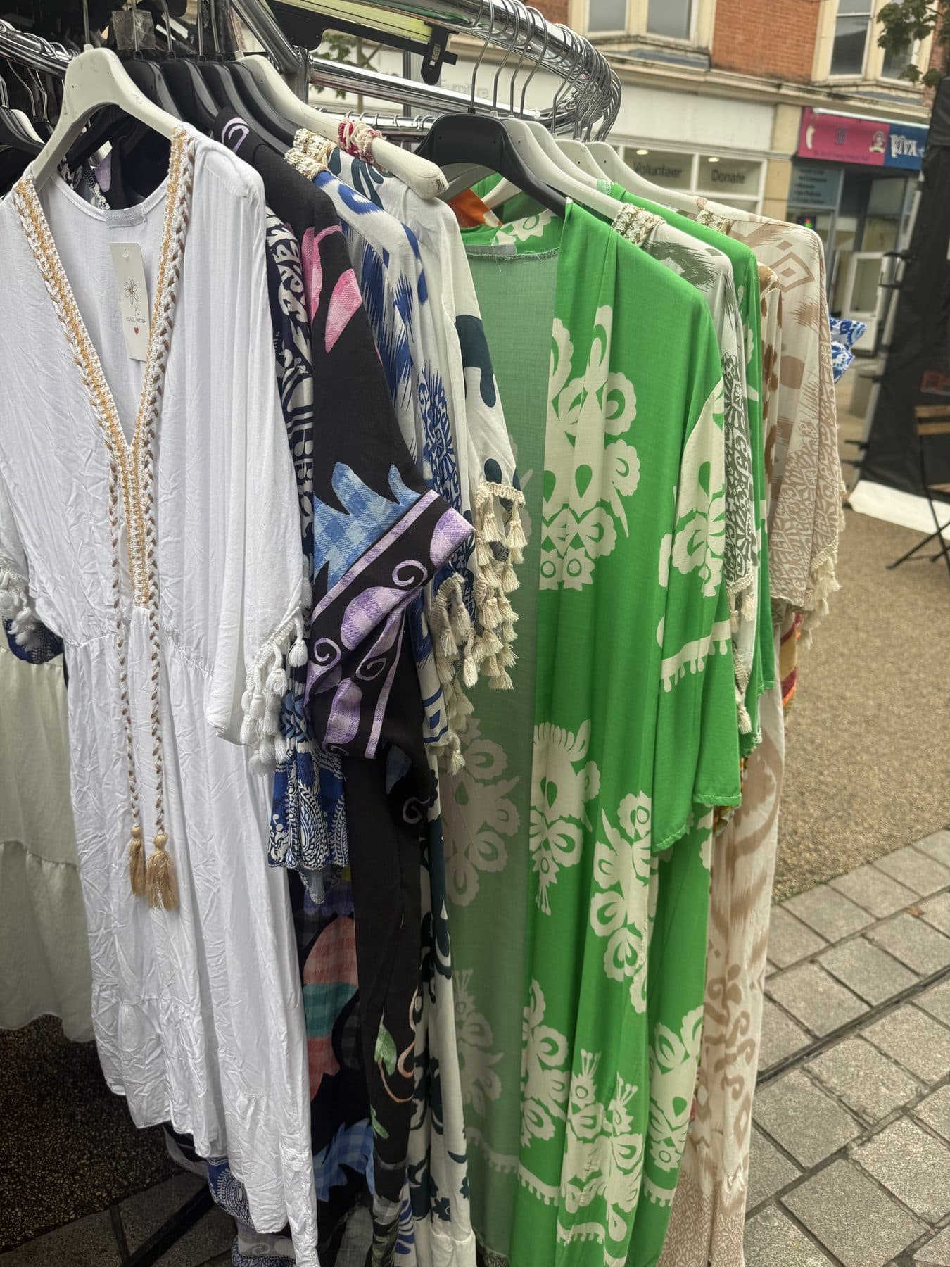 Printed kaftans and summer dresses on the rail